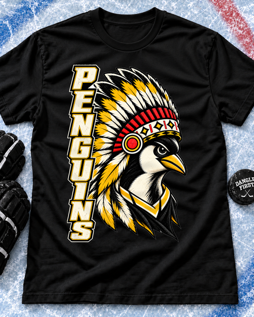 Black Manitoba Penguins Heritage T-shirt featuring vertical cream PENGUINS lettering and a distressed gold, white, red, and black penguin mascot illustration.